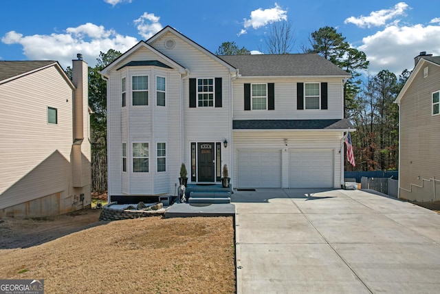 traditional home featuring a garage, concrete driveway, and a shingled roof