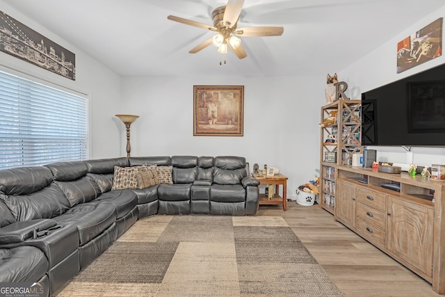 living area featuring light wood-style floors and ceiling fan