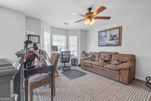 office area with visible vents, baseboards, ceiling fan, and wood finished floors