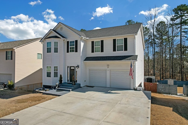 traditional-style house with roof with shingles, concrete driveway, and an attached garage