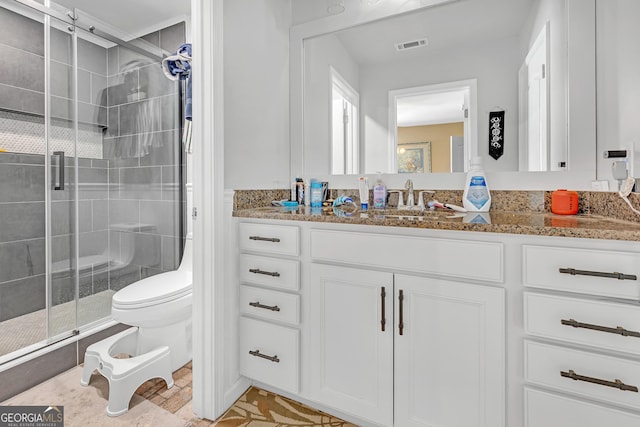 full bathroom with visible vents, a stall shower, toilet, and vanity