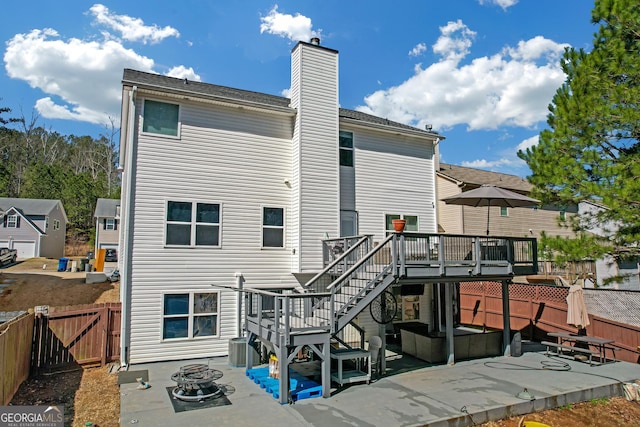 back of property featuring an outdoor fire pit, stairs, a fenced backyard, a deck, and a patio area