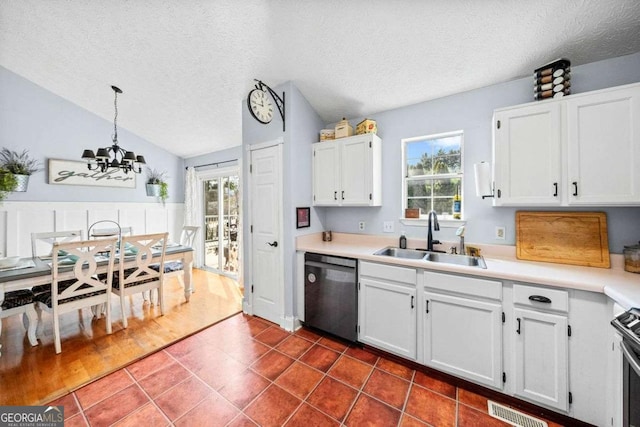 kitchen featuring visible vents, dishwasher, stainless steel range oven, white cabinets, and a sink