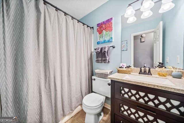 full bathroom with tile patterned floors, toilet, a textured ceiling, a shower with shower curtain, and vanity