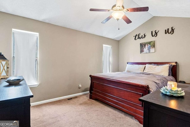 bedroom with visible vents, baseboards, lofted ceiling, ceiling fan, and light colored carpet