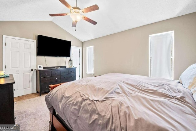 bedroom featuring carpet, a ceiling fan, and vaulted ceiling