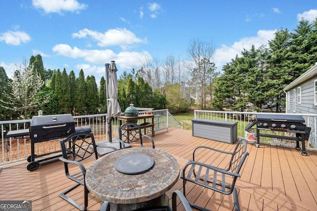 wooden deck featuring grilling area and outdoor dining space