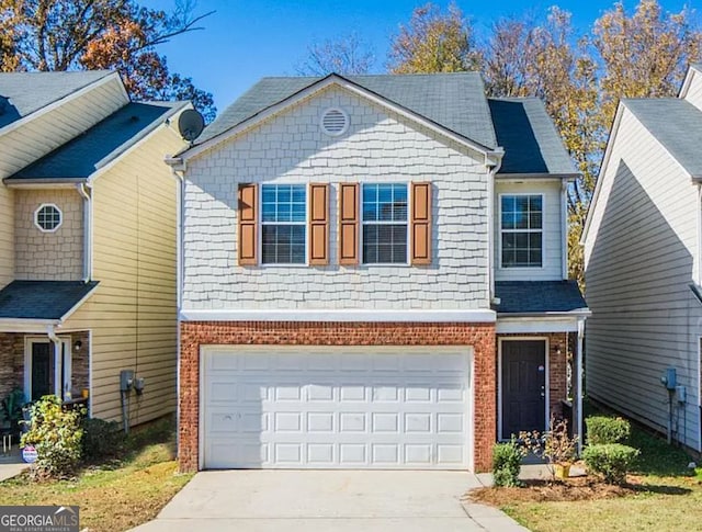 traditional-style house featuring brick siding, concrete driveway, and an attached garage