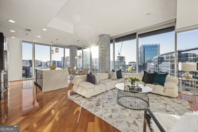 1080 Peachtree St NE Unit 2011, Atlanta, GA 30309 - living room with a view of city, light wood-style flooring, recessed lighting, and a wall of windows