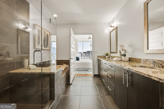 bathroom with double vanity, a sink, tile patterned flooring, a shower stall, and a bath