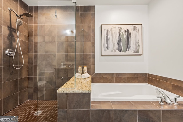 bathroom with tiled shower and a garden tub