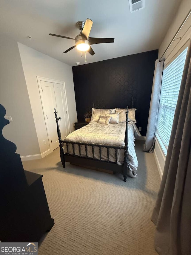 bedroom featuring visible vents, baseboards, a ceiling fan, and carpet flooring