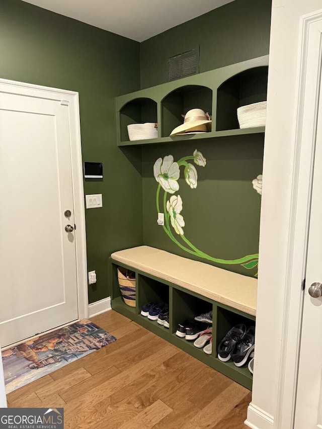 mudroom with baseboards and wood finished floors