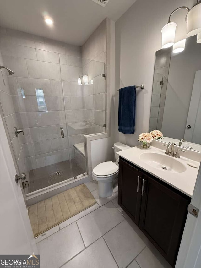 full bathroom featuring tile patterned floors, toilet, a stall shower, and vanity