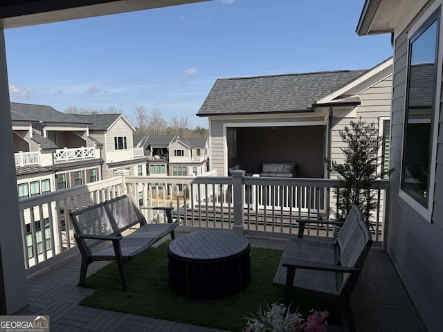 wooden deck with a residential view and an outdoor hangout area