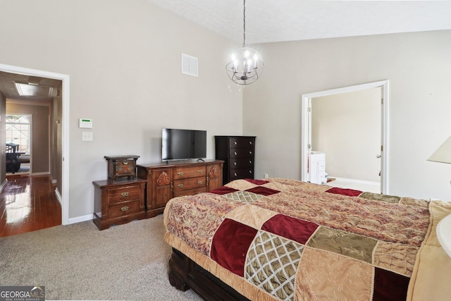 carpeted bedroom with visible vents, baseboards, and a chandelier