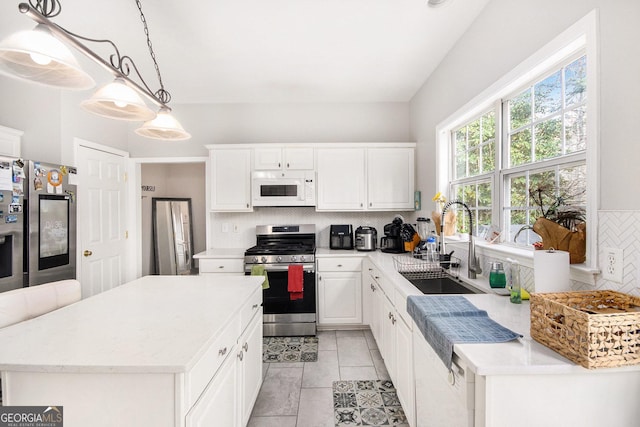 3550 Myrtlewood Chase NW, Kennesaw, GA 30144 - kitchen with stainless steel appliances, tasteful backsplash, white cabinetry, pendant lighting, and light tile patterned flooring
