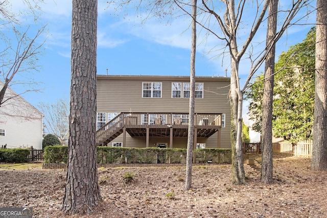 back of house with a wooden deck and fence