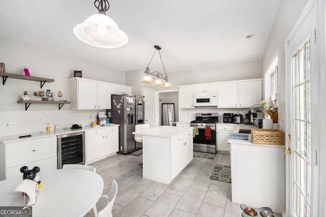 3550 Myrtlewood Chase NW, Kennesaw, GA 30144 - kitchen featuring appliances with stainless steel finishes, beverage cooler, a center island, decorative backsplash, and white cabinetry