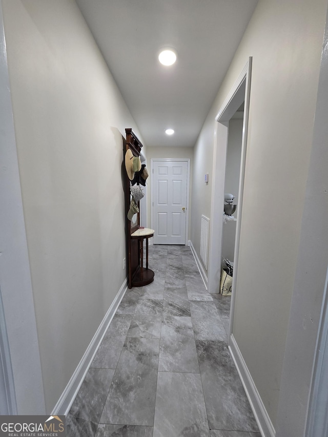 hall with visible vents and baseboards