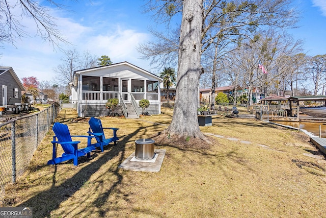 view of yard with fence and a sunroom