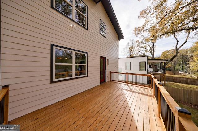 wooden terrace featuring fence