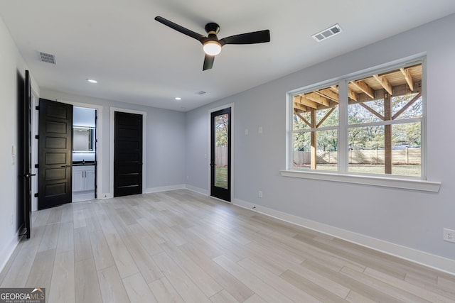 unfurnished bedroom with visible vents, light wood-type flooring, and baseboards