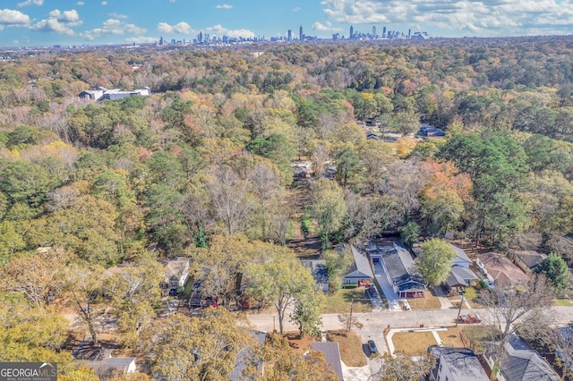 drone / aerial view with a view of city and a view of trees