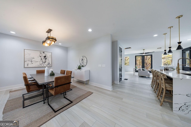 dining room featuring recessed lighting, light wood-type flooring, and baseboards