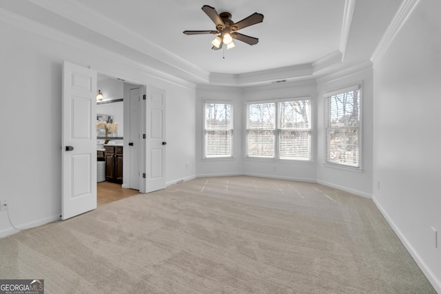 1654 Summersweet Ln, Dacula, GA 30019 - unfurnished bedroom with light carpet, crown molding, a tray ceiling, connected bathroom, and a ceiling fan