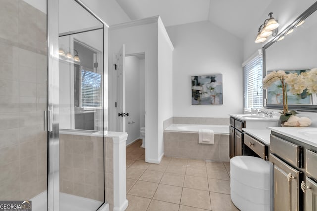 1654 Summersweet Ln, Dacula, GA 30019 - bathroom featuring tile patterned floors, vanity, a garden tub, a shower stall, and vaulted ceiling