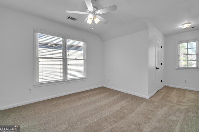 full bath featuring a bath, a stall shower, vaulted ceiling, tile patterned floors, and toilet