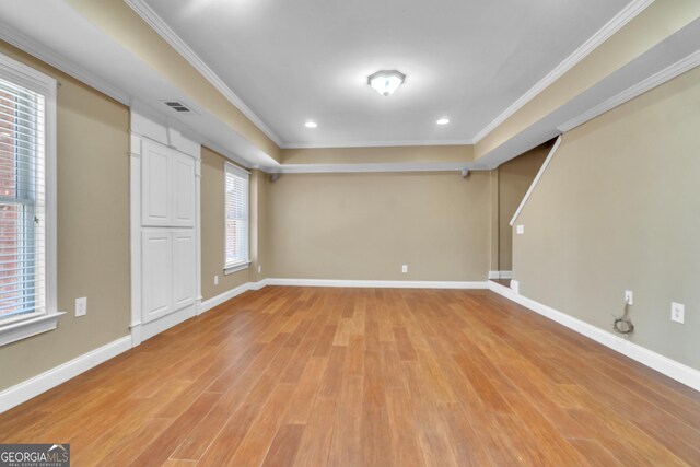 unfurnished room featuring baseboards, light wood finished floors, and ornamental molding