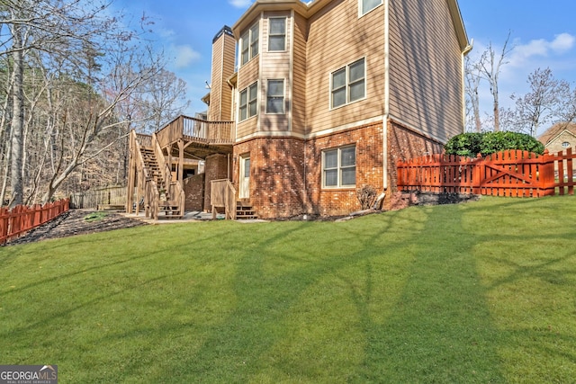 1654 Summersweet Ln, Dacula, GA 30019 - back of house featuring brick siding, a fenced backyard, a wooden deck, and stairway