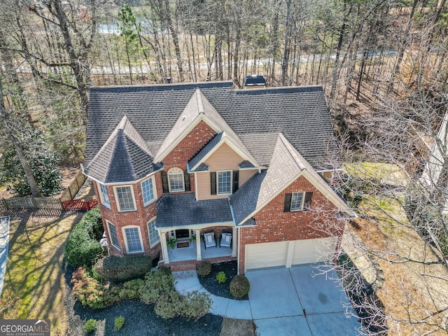 1654 Summersweet Ln, Dacula, GA 30019 - view of front facade with roof with shingles, concrete driveway, a porch, and brick siding