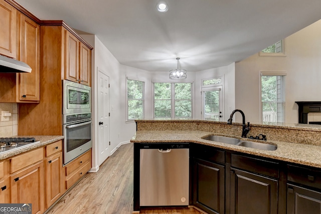 1654 Summersweet Ln, Dacula, GA 30019 - kitchen with appliances with stainless steel finishes, light wood finished floors, light stone countertops, backsplash, and recessed lighting