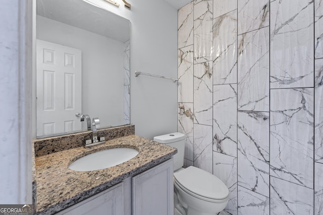 bathroom featuring vanity and toilet