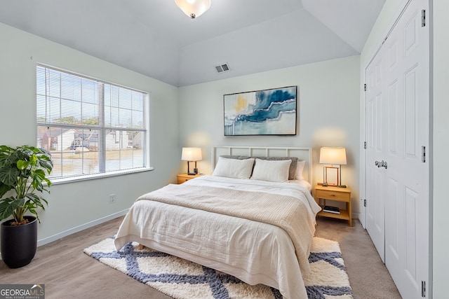 bedroom with visible vents, baseboards, and lofted ceiling