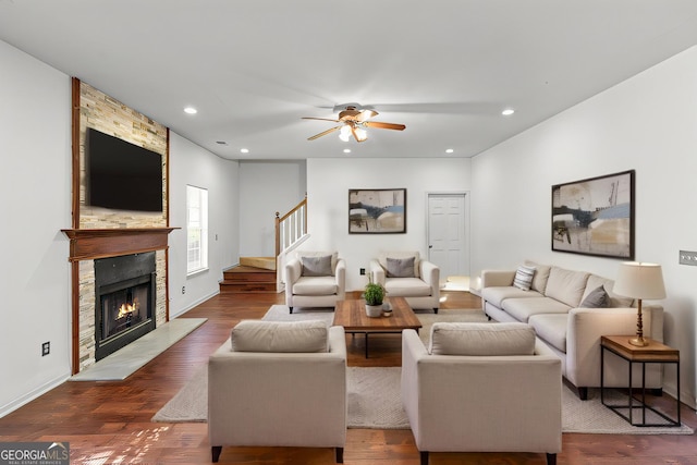 living area with dark wood finished floors, stairway, recessed lighting, and a fireplace