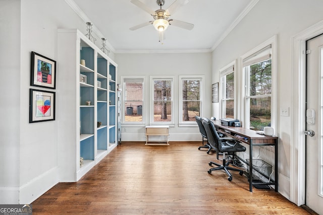 home office featuring baseboards, crown molding, ceiling fan, and wood finished floors