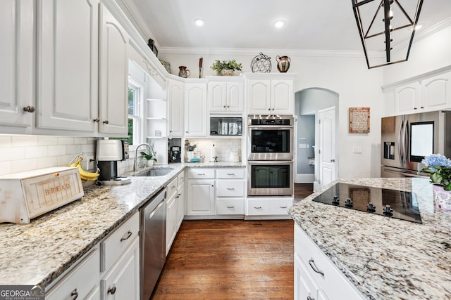 kitchen with dark wood finished floors, ornamental molding, arched walkways, black appliances, and a sink