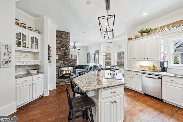 kitchen featuring stainless steel dishwasher, decorative backsplash, dark wood finished floors, and ornamental molding