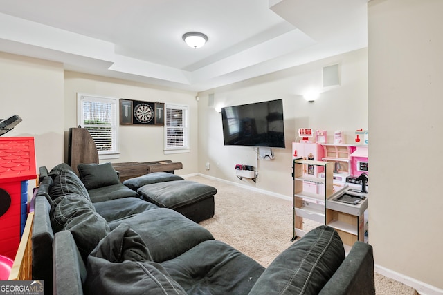 living room with baseboards, carpet, and a tray ceiling