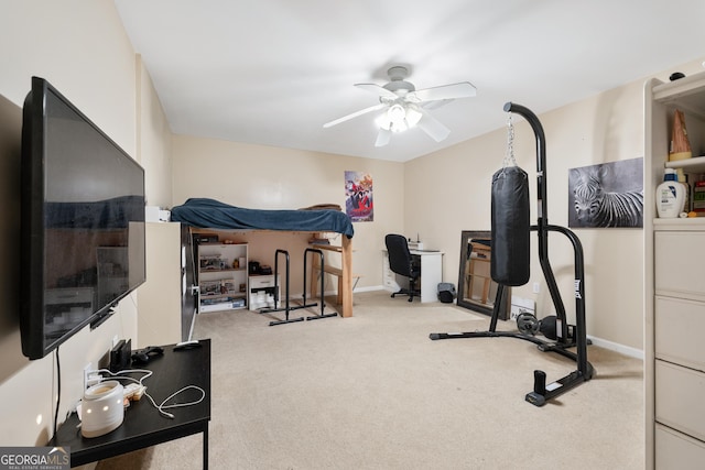 exercise area featuring carpet flooring, a ceiling fan, and baseboards