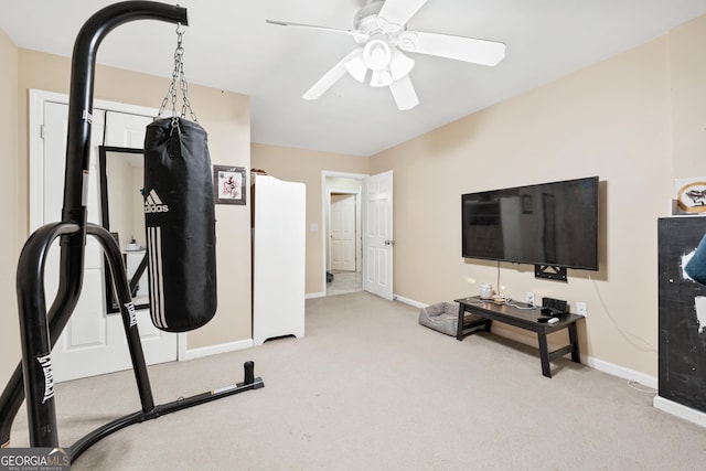 workout room featuring ceiling fan, baseboards, and carpet floors