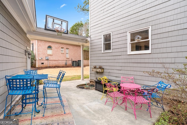 view of patio featuring outdoor dining area, central AC, and fence