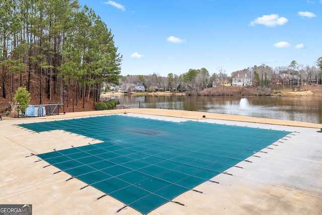 view of swimming pool with a water view and a patio area