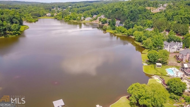 drone / aerial view featuring a view of trees and a water view