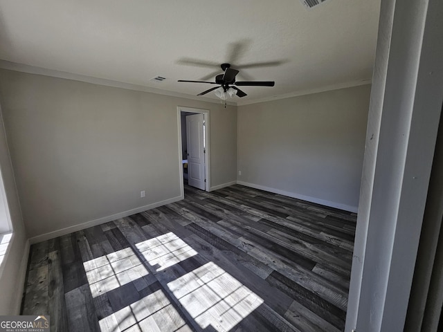 unfurnished room featuring a ceiling fan, dark wood-style floors, baseboards, and ornamental molding