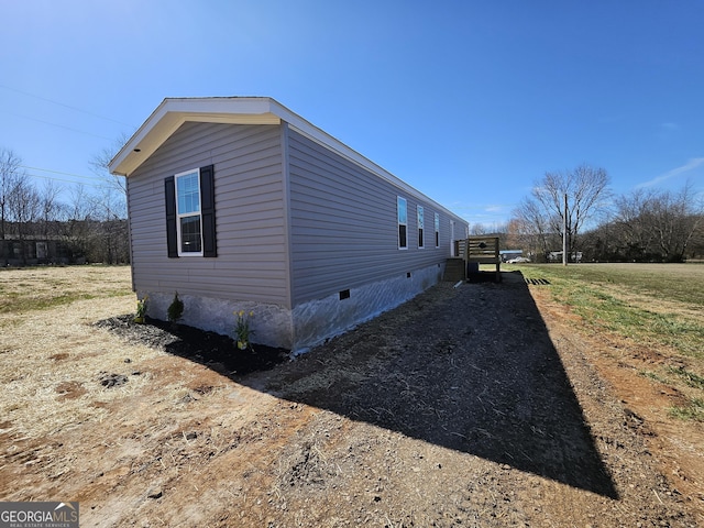 view of side of home with crawl space